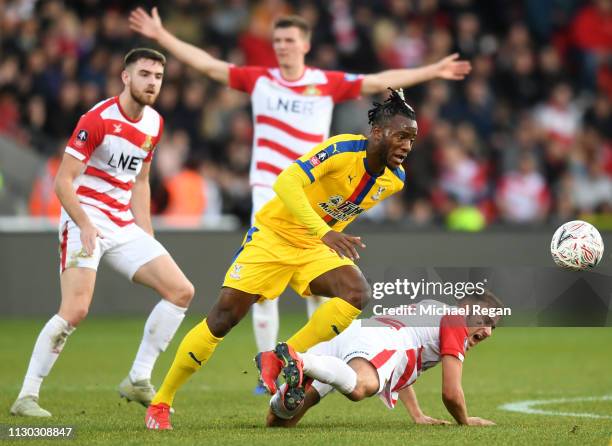 Michy Batshuayi of Crystal Palace battles with Herbie Kane of Doncaster Rovers during the FA Cup Fifth Round match between Doncaster Rovers and...