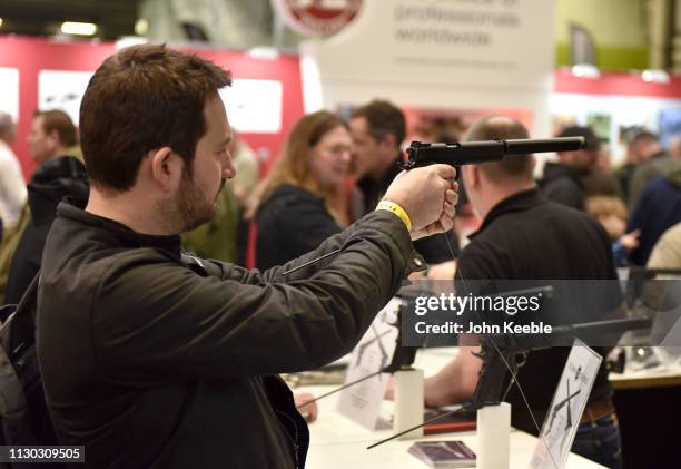 Visitor holds an Oceania Defence Colt 1911 LBP at the Great British Shooting Show at NEC Arena on February 15, 2019 in Birmingham, England. The show...