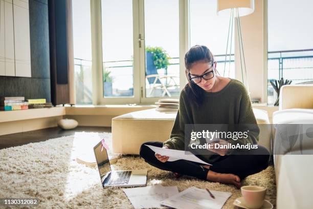 young woman working from home - mobile phone on floor stock pictures, royalty-free photos & images