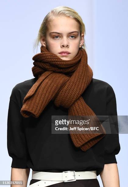 Model, scarf detail, walks the runway at the Margaret Howell show during London Fashion Week February 2019 on February 17, 2019 in London, England.