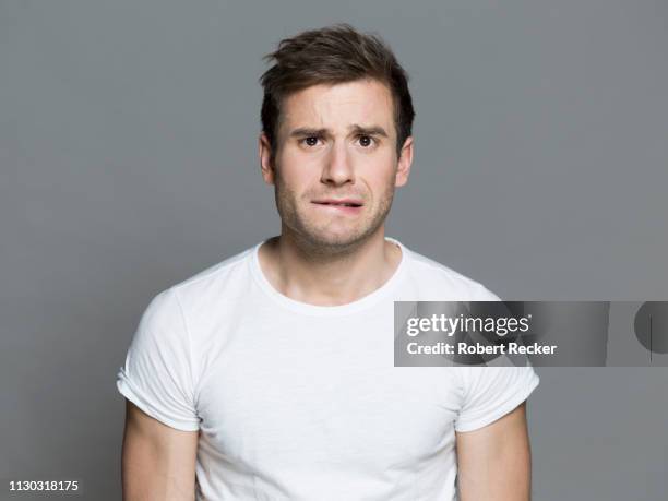 embarrassed young man - scared portrait stock pictures, royalty-free photos & images