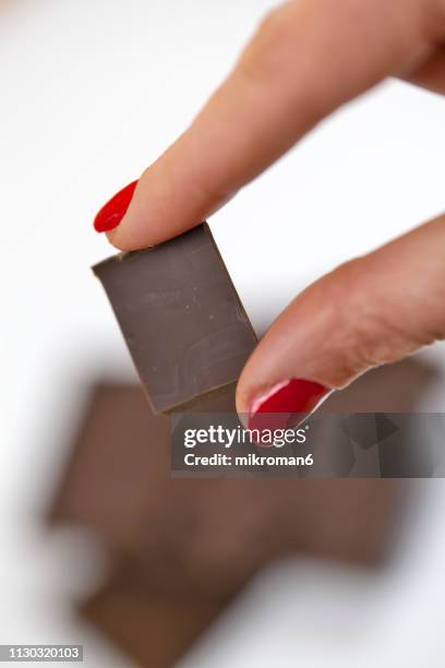 woman holding chocolate chunks - dark chocolate stock pictures, royalty-free photos & images