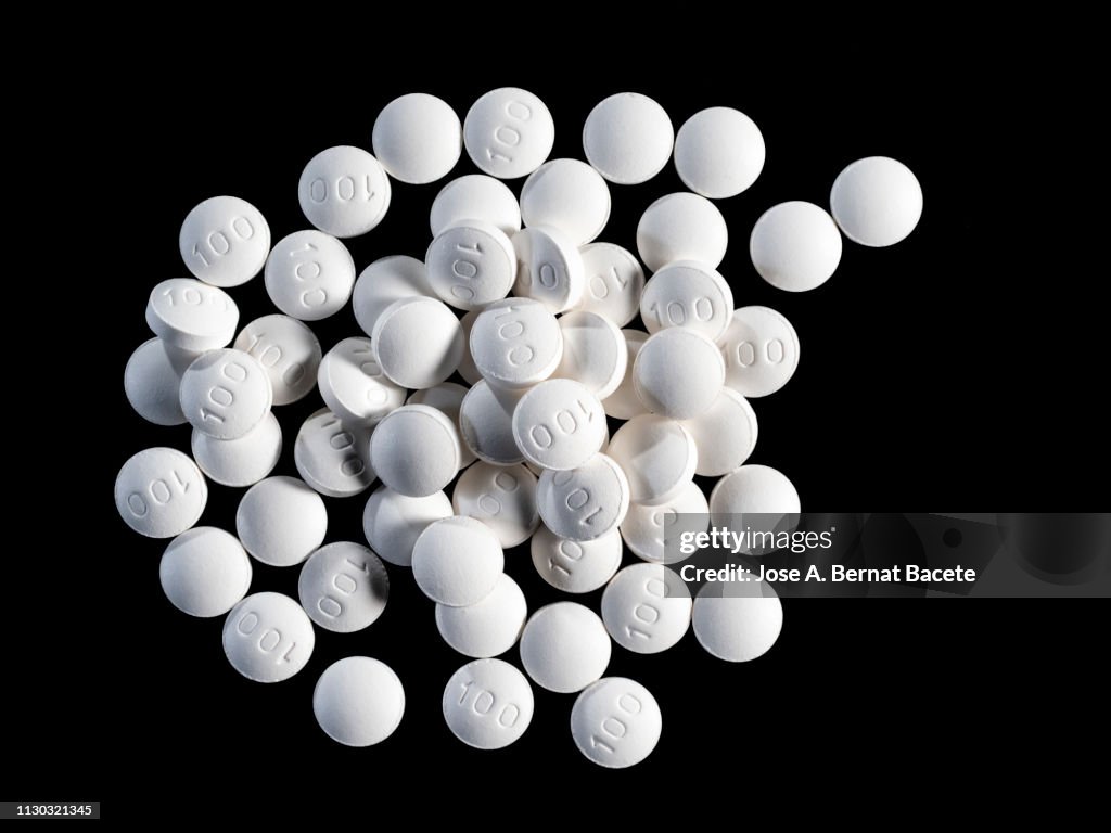 Full frame heap of tablets of medicines of white color.