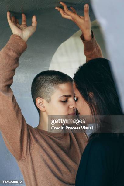 portrait of young lesbian couple - quirky kissing foto e immagini stock