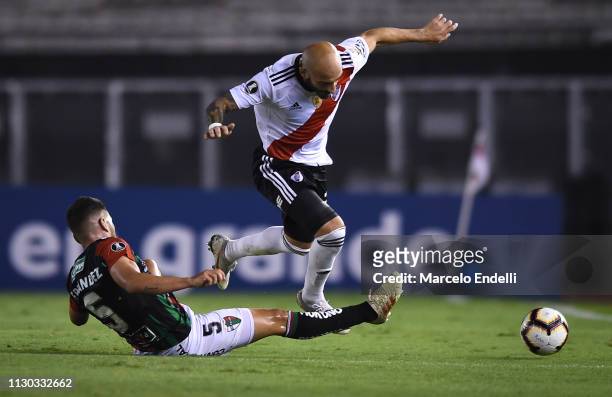 Javier Pinola of River Plate fights for the ball with Julian Fernandez of Palestino during a group A match between River Plate and Palestino as part...