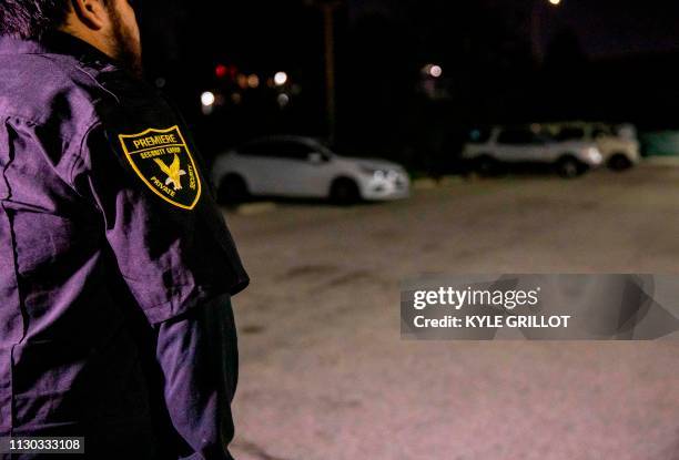 Security member stands in the Safe Parking LA parking lot near the Veteran's Affairs Los Angeles Healthcare Center in Los Angeles, California,...