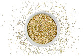 Sesame seeds in a bowl isolated on white background