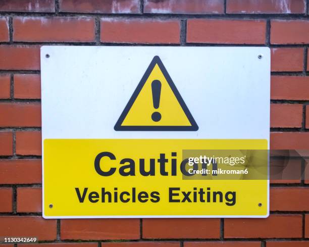 caution vehicles exiting sign - warning sign stock pictures, royalty-free photos & images