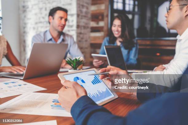 group of people meeting with technology. - business strategy stock pictures, royalty-free photos & images