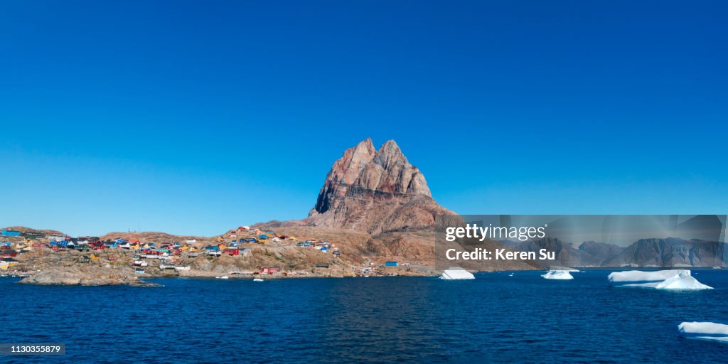 Brightly painted houses on the island with floating ice, Uummannaq, Greenland