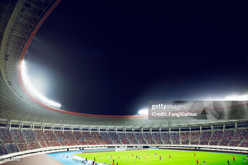 Soccer game in a stadium at night