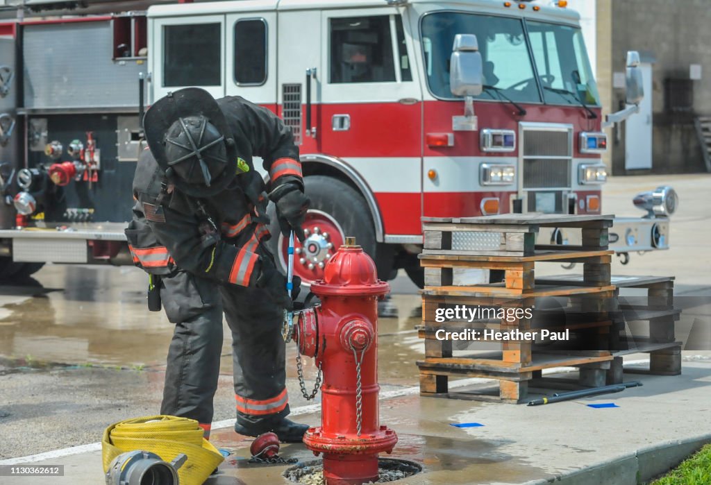Fire Engine Fire Hydrant Firefighter Opening A Fire Hydrant In Front Of A Fire Truck High-Res ...