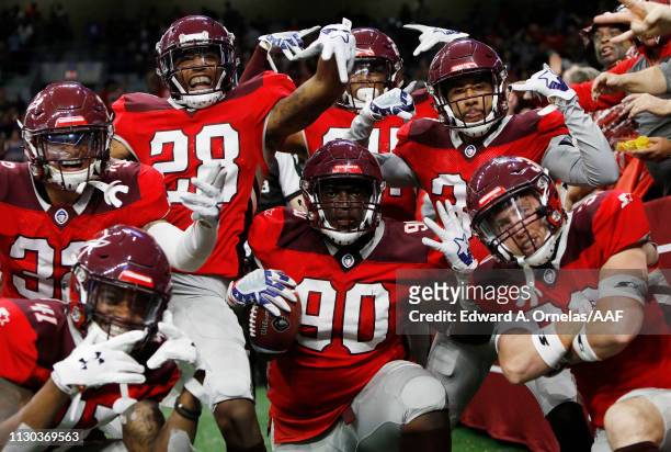 Joey Mbu of the San Antonio Commanders celebrates with teammates after a fumble return touchdown during the third quarter against the Orlando Apollos...