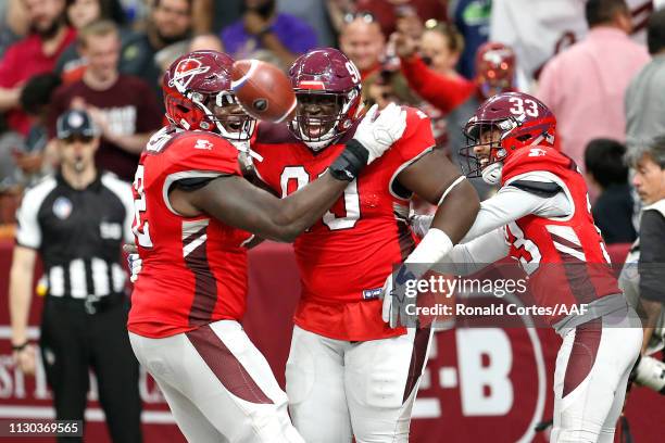 Joey Mbu of the San Antonio Commanders celebrates with teammates after a fumble return touchdown during the third quarter against the Orlando Apollos...