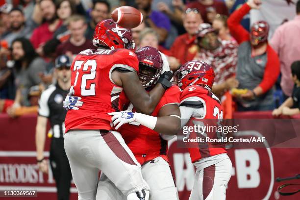 Joey Mbu of the San Antonio Commanders celebrates with teammates after a fumble return touchdown during the third quarter against the Orlando Apollos...