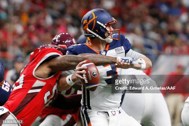 Garrett Gilbert of the Orlando Apollos fumbles the ball as he is sacked by Jayrone Elliott of the San Antonio Commanders during the third quarter in...