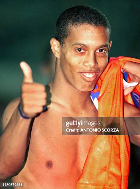 Brazil's Ronaldinho Gaucho of the Sub 23 selection team celebrates with a Chilean jersey after the victory over Chile 04 February, 2000 in Londrina...