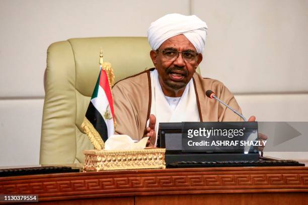 Sudan's President Omar al-Bashir attends a meeting with his new 20-member cabinet as they take oath at the presidential palace in the capital on...