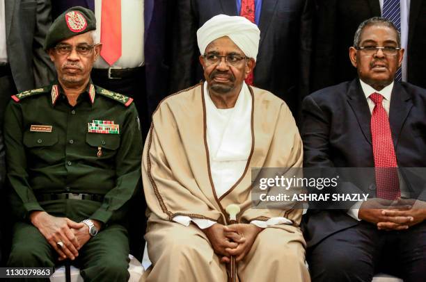 Sudan's President Omar al-Bashir is seated alongside his first vice president Lieutenant General Awad Mohamed Ahmed ibn Auf and Prime Minister...