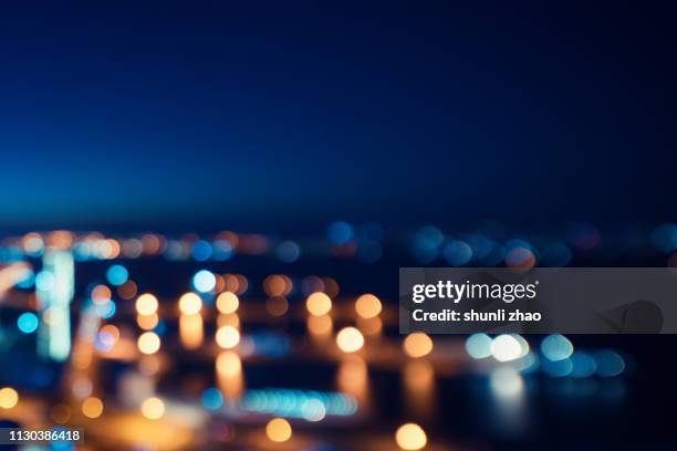 street lights of urban city street at night - foco difuso fotografías e imágenes de stock