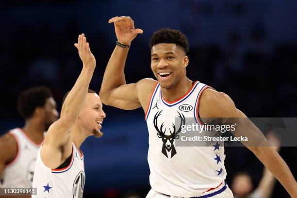 Giannis Antetokounmpo of the Milwaukee Bucks and Team Giannis celebrates with Stephen Curry of the Golden State Warriors against Team LeBron in the...