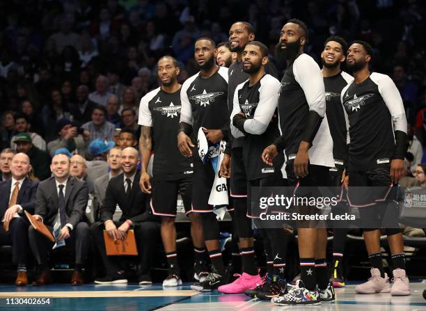 Members of Team LeBron watch play from the bench in the third quarter during the NBA All-Star game as part of the 2019 NBA All-Star Weekend at...