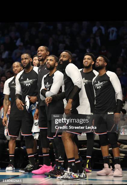 Members of Team LeBron watch play from the bench in the third quarter during the NBA All-Star game as part of the 2019 NBA All-Star Weekend at...