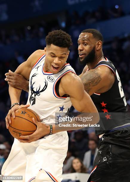 Giannis Antetokounmpo of the Milwaukee Bucks and Team Giannis fights to keep the ball against LeBron James of the LA Lakers and Team LeBron in the...