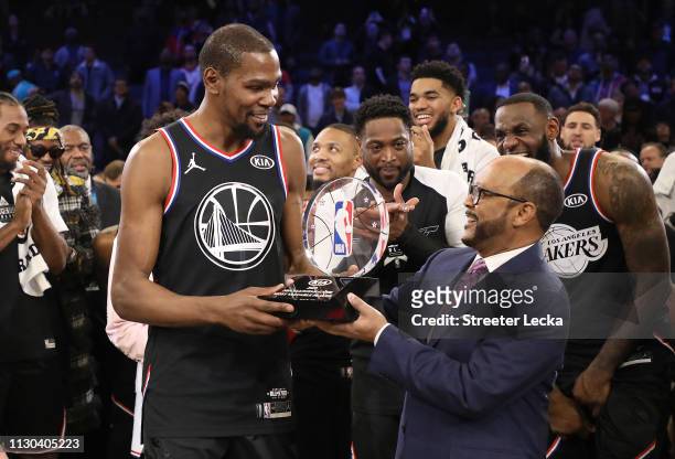 Kevin Durant of the Golden State Warriors and Team LeBron is awarded the MVP trophy after their 178-164 win over Team Giannis during the NBA All-Star...