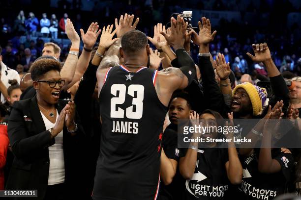 LeBron James of the LA Lakers and Team LeBron celebrates with representatives of the Right Moves for Youth Charlotte charity after their 178-164 win...
