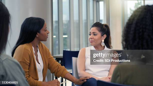 female counselor listens compassionately during support group - vulnerability management stock pictures, royalty-free photos & images
