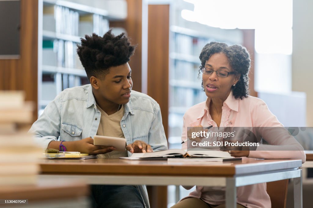 Volunteer Tutor Helps High School Student HighRes Stock Photo Getty