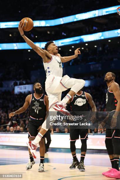 Giannis Antetokounmpo of the Milwaukee Bucks and Team Giannis goes up to dunk against James Harden of the Houston Rockets and Kevin Durant of the...