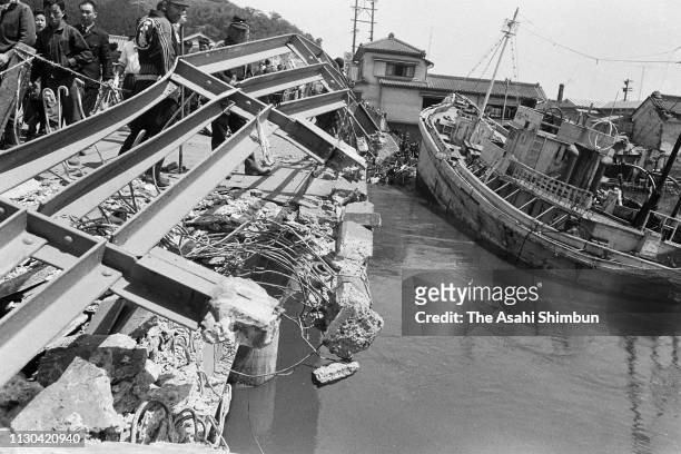 Railing of a bridge is damaged while a fish boat is washed waway by a tsunami triggered by Valdivia earthquake in Chile on May 24, 1960 in Ofunato,...