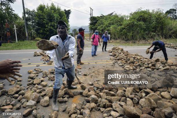 Indigenous people set up a barricade with stones to block the Pan-American highway during a protest in La Agustina, rural area of Santander de...