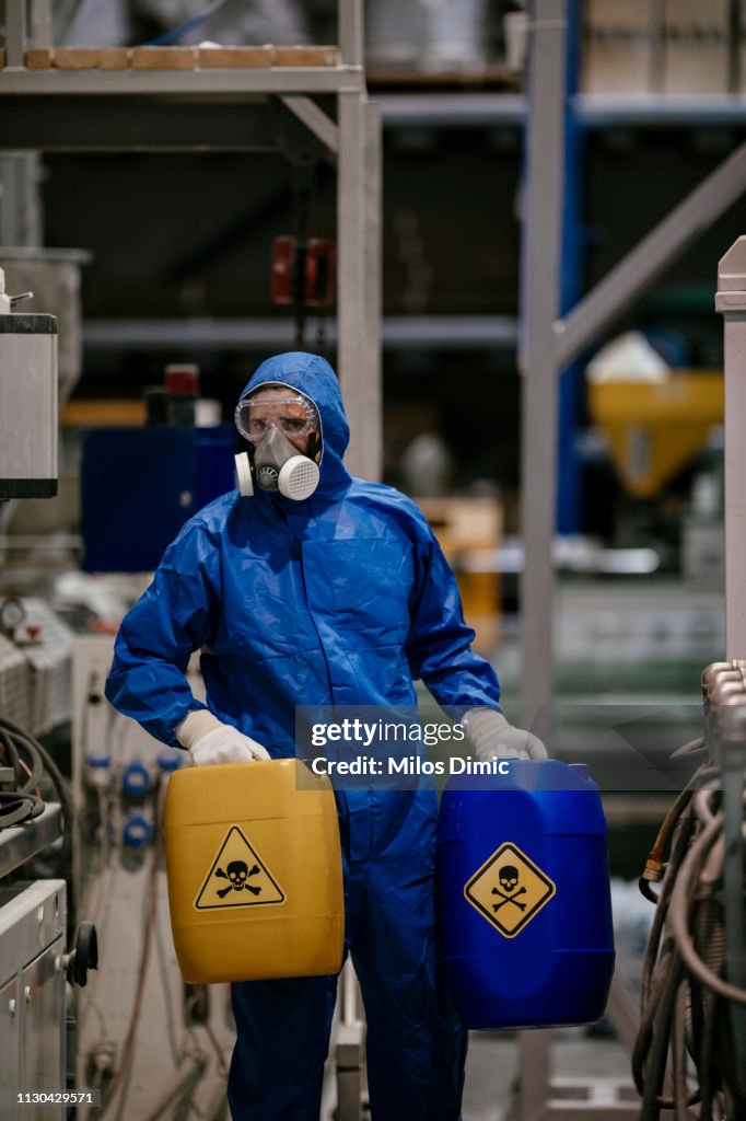Factory worker working with dangerous materials