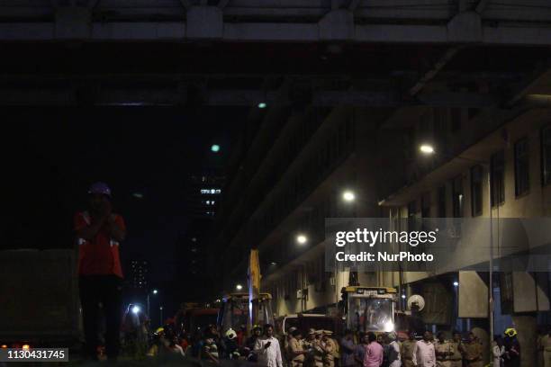 Rescue workers talks on a mobile phone at the site of a footbridge after its collapse, outside the Chhatrapati Shivaji Maharaj Terminus railway...