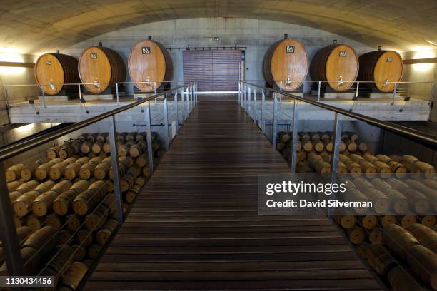 Wine ages in French oak casks in the barrel cellar of the automated production multi-level hall at Bodegas Baigorri gravitational winery welcomes...