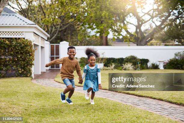 letting out all their energy outdoors - sibling day stock pictures, royalty-free photos & images