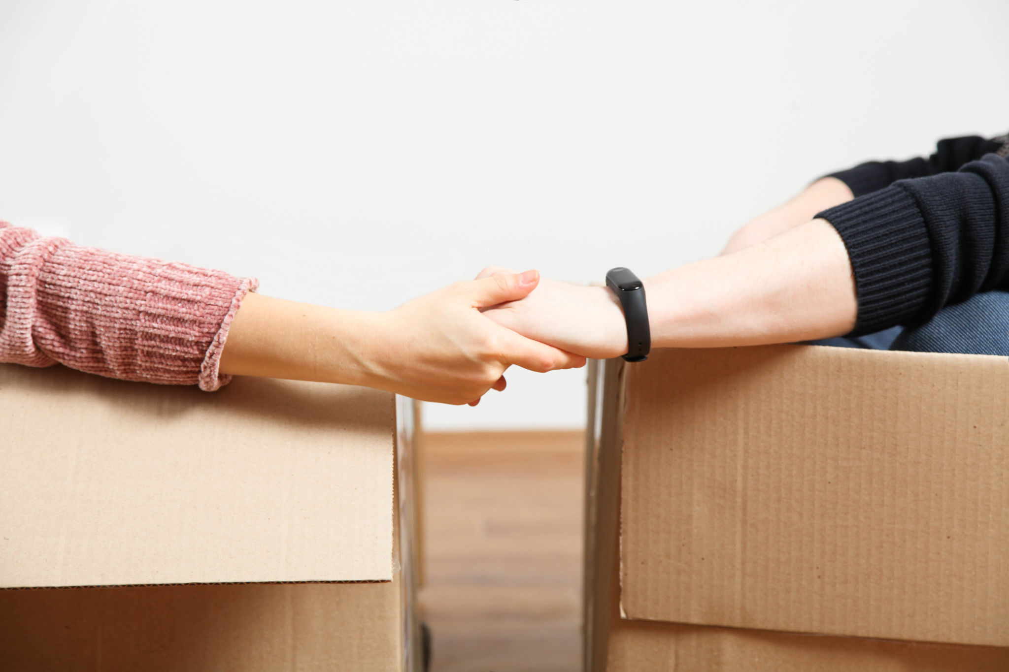 couple sit in boxes and hold hands couple sit in boxes and hold hands
