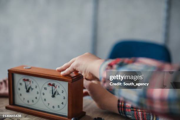 pressing a button on chess clock - chess timer stock pictures, royalty-free photos & images