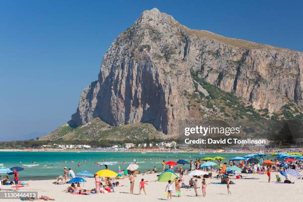 view along crowded beach to monte monaco, san vito lo capo, trapani, sicily, italy - monaco national day stock pictures, royalty-free photos & images