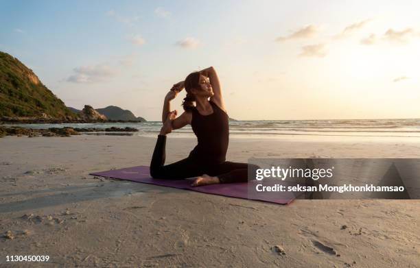 yoga - asian on beach stock pictures, royalty-free photos & images