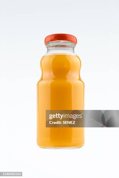 bottles of fruit juice - orangensaft stock-fotos und bilder