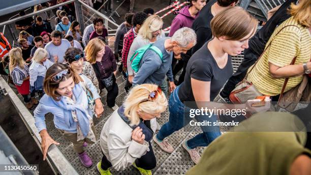 group of spectators entering stadium - entering imagens e fotografias de stock