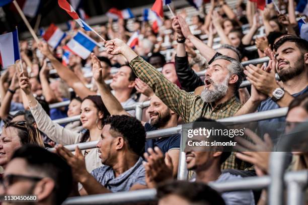 Cheering Definition Stadium Crowd Cheering And Clapping Waving Flags Photos and Premium ...