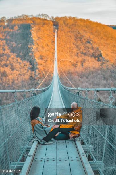 the most beautiful hike i've ever been on - person on suspension bridge stock pictures, royalty-free photos & images