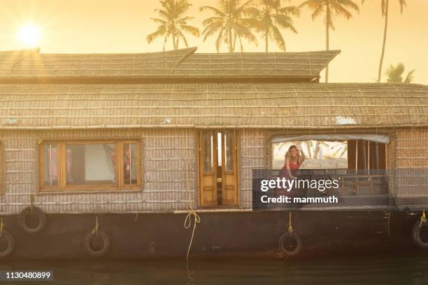 happy mature woman on a houseboat-trip in kerala, india - houseboat stock pictures, royalty-free photos & images
