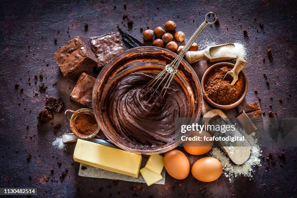 chocolate brownie ingredients on kitchen table - mixing bowl stock pictures, royalty-free photos & images