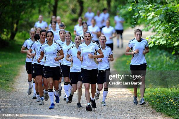 Goalkeeper Nadine Angerer and her team mates warm up during a German Women National Team training session at Villaforstpark on April 23, 2011 in...